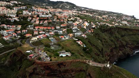 Fly-Over-Cristo-Rei---Sacred-Heart-Statue-And-Townscape-In-Garajau,-Madeira,-Caniço,-Portugal