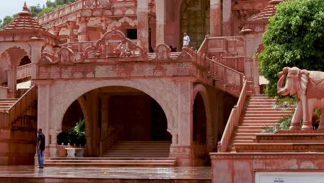 artistic-red-stone-jain-temple-at-morning-from-unique-angle-video-is-taken-at-Shri-Digamber-Jain-Gyanoday-Tirth-Kshetra,-Nareli-Jain-Mandir,-Ajmer,-Rajasthan,-India-an-Aug-19-2023.