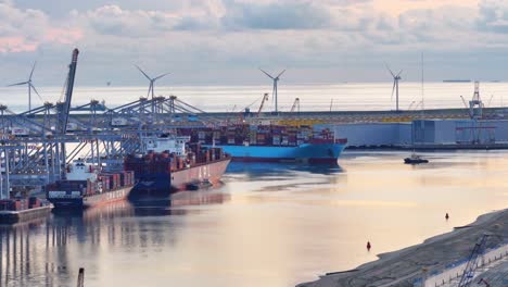 Large-container-ship-arriving-at-the-Rotterdam-World-Gateway-terminal,-aerial