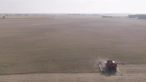 High-Aerial-Side-View-of-Combine-Harvester-in-Expansive-Soybean-Field-on-Hazy-Hot-Day