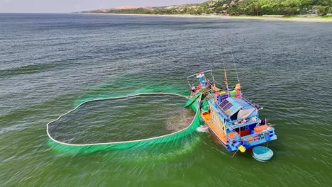 Drone-view-of-fishing-boat-is-netting-anchovy-on-the-sea-of-Ke-Ga,-Binh-Thuan-province,-central-Vietnam