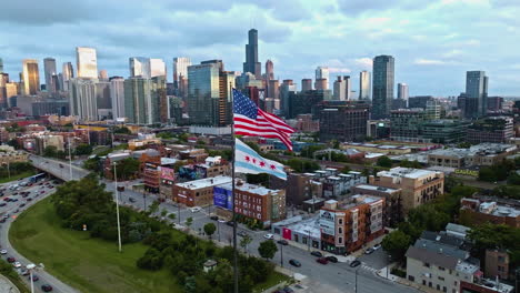 Aerial-view-approaching-the-US-and-Chicago-Flag-with-skyline-background