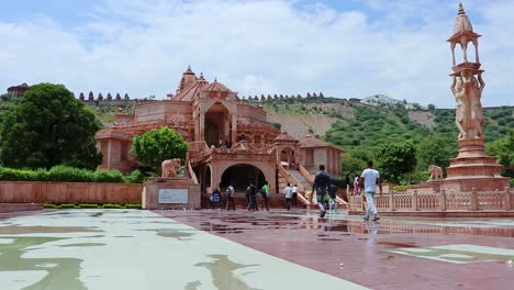 artistic-red-stone-jain-temple-at-morning-from-unique-angle-video-is-taken-at-Shri-Digamber-Jain-Gyanoday-Tirth-Kshetra,-Nareli-Jain-Mandir,-Ajmer,-Rajasthan,-India-an-Aug-19-2023.