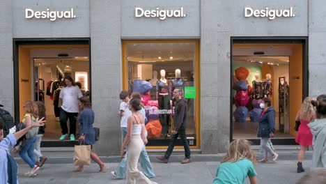 Pedestrians-and-shoppers-walk-past-the-Spanish-clothing-brand-Desigual-store-in-Spain