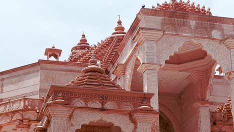 artistic-hand-carved-red-stone-jain-temple-at-morning-from-unique-angle-video-is-taken-at-Shri-Digamber-Jain-Gyanoday-Tirth-Kshetra,-Nareli-Jain-Mandir,-Ajmer,-Rajasthan,-India-an-Aug-19-2023