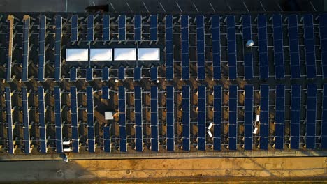 drone-shot-of-Solar-panels-on-the-Kaunas-University-of-Technology-building-rooftop-in-Kaunas,-Lithuania,-top-down-shot
