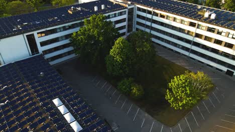 drone-shot-of-Solar-panels-on-the-Kaunas-University-of-Technology-building-rooftop-in-Kaunas,-Lithuania,-zoom-in
