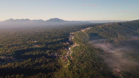 Aerial-view-overlooking-the-Kintamani-village,-misty-morning-in-Bali,-Indonesia
