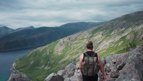 Male-Backpacker-Hiking-Kvaenan-Mountain-In-Norway---static-shot