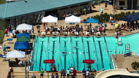 Spectators-Watching-Participants-Swim-In-The-Pool-During-Swimming-Meet