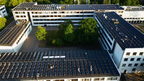 drone-shot-of-Solar-panels-on-the-Kaunas-University-of-Technology-building-rooftop-in-Kaunas,-Lithuania