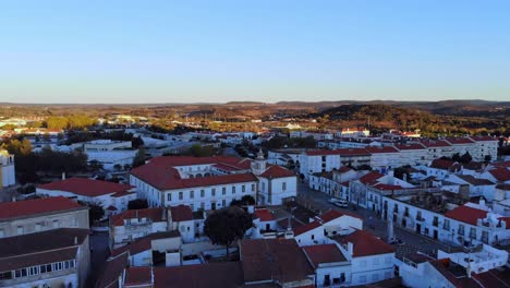 Drone-shot-flying-over-a-little-village-of-white-houses-with-red-roofs-in-Alentejo,-Portugal