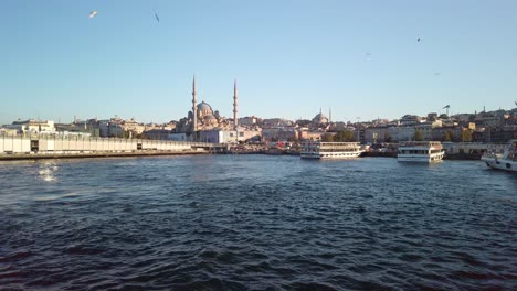 Evening,-cinematic-slow-mo,-a-mesmerizing-view-of-Eminonu-from-a-ferry-on-the-Golden-Horn-in-Istanbul