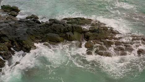 Ocean-waves-hit-against-rocky-shoreline-at-Looc-Beach,-Surigao,-Philippines