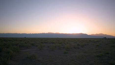 Sunrise-peeking-over-the-La-Sal-Mountains-in-Crestone-Colorado,-static-time-lapse