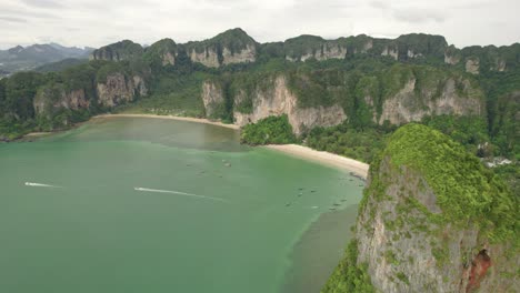 Thailand's-Natural-Wonder-at-Railay-Beach-and-Turquoise-Waters-Meet-Majestic-Limestone-Cliffs-from-an-Aerial-Drone-Overhead-in-Thailand