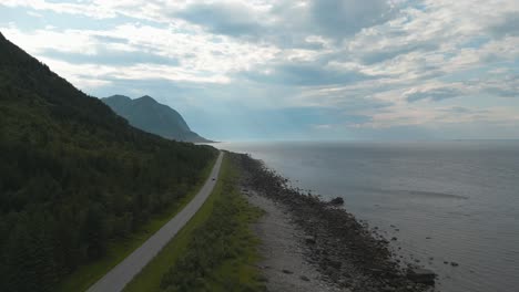 Fjord-road-in-Norway:-Forward-moving-shot-over-a-road-passing-Norwegian-sea-in-the-mountains-of-northen-Norway-at-daytime