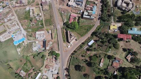 Aerial-top-down-view-on-asphalt-road-leading-to-Loitokitok-town,-Kenya
