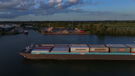 Freight-vessel-full-of-cargo-passes-the-town-of-Barendrecht-on-the-Oude-Maas-river