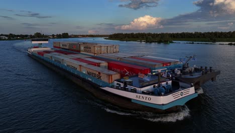 Sento,-a-freight-vessel-sailing-past-the-town-of-Barendrecht,-Netherlands