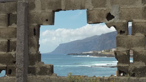 Paradise-beach-framed-by-broken-wall,-contrasts,-Tenerife,-Canary-islands