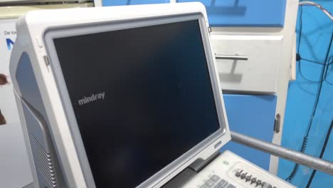 Dolly-in-and-out-shot-of-an-electronic-ultrasound-machine-in-a-veterinary-clinic