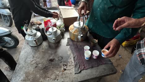 Tea-shop-scene,-people-are-filling-tea-in-paper-cups