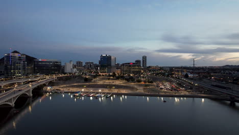 Tempe-City-Skyline-Over-Salt-River-with-City-Lights-During-Twilight-with-an-Aerial-Drone,-Arizona,-USA