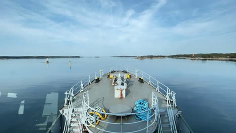 Tug-boat-travelling-across-narrow-Finnish-archipelago-fairway-during-summer-day