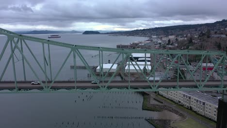 Drone-flying-parallel-to-the-Astoria-Megler-Bridge,-tracking-cars-crossing-the-bridge