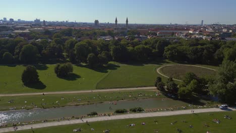 Gorgeous-aerial-top-view-flight-police-car-driving-in-park-English-Garden-Munich-Germany-Bavarian,-summer-sunny-blue-sky-day-23