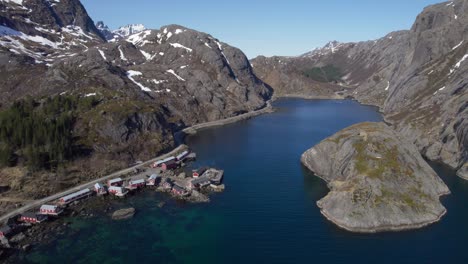 Aerial-forwarding-shot-of-the-road-to-Nusfjord,-old-fishing-village-in-Lofoten