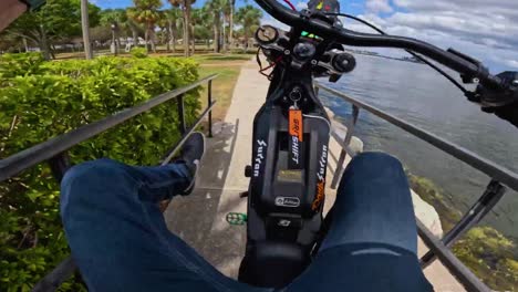 FPV-guy-going-down-the-slop-on-a-ebike,-performing-stunts-wheelies