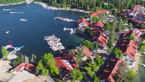 hyper-lapse-over-Lake-Arrowhead-Village-California-busy-city-boats-and-yachts-on-water-bright-colored-buildings-sunny-day-vibrant-AERIAL-RAISE-PAN-TILT