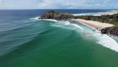 Norries-Head-And-Cabarita-Beach-With-Surfers-In-New-South-Wales,-Australia---aerial-shot