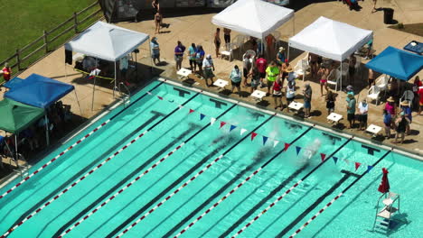 Swimmers-On-Backstroke-Start-Position-During-Swimming-Meet