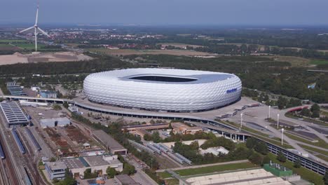 Magic-aerial-top-view-flight-Bavarian-Munich-Arena-stadium-national-football-soccer-team-Germany,-summer-sunny-blue-sky-day-23