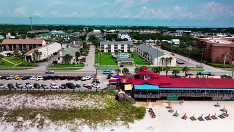 Pompano-Joes-restaurant-and-parking-lot-trucking-left-aerial-drone-shot-with-a-view-of-old-98-highway-in-Destin-Florida