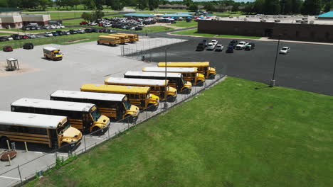 School-Buses-On-Parking-Lot-In-Siloam-Springs,-Arkansas,-USA