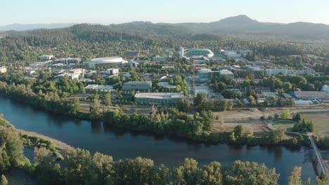 drone-fly-above-Eugene,-Oregon-USA-approaching-Autzen-football-stadium-during-a-sunny-day