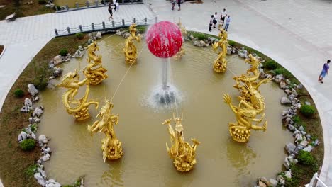 Aerial-rotate-around-dragon-water-fountain-classic-traditional-Chinese-architecture-in-Weihai-Huaxiacheng-China