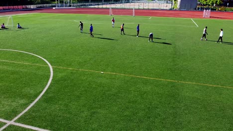 Mini-stadium-with-international-students-playing-football-soccer-in-Beijing-Jioatong-University,-Weihai