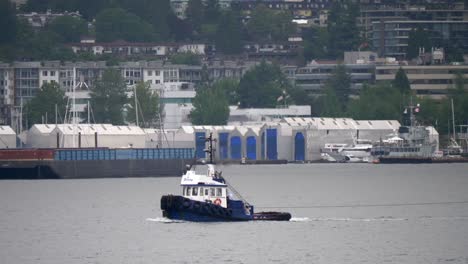 Isolated-Tugboat-in-Harbour-on-an-Overcast-Day---Track-with-Long-Lens