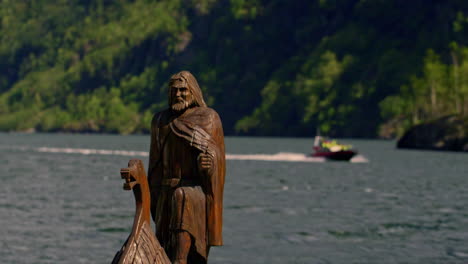 Shot-of-Vikings-Wooden-Ship-Replica-docked-along-the-shore-in-Viking-Valley,-Norway-on-a-sunny-day