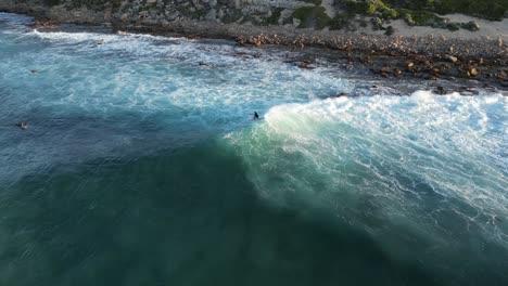 High-aerial-view-of-a-surfer-riding-ocean-waves-in-Australia
