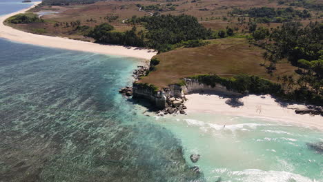 Aerial-View-Of-Pantai-Watu-Bella-Beach-With-White-Sand-and-Crystal-Clear-Water-On-A-Sunny-Day-In-Sumba-Island,-Indonesia