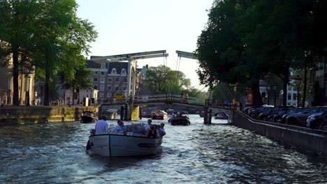 Tourists-On-Tour-Boats-Over-Scenic-Canals-In-Amsterdam,-South-Holland,-Netherlands