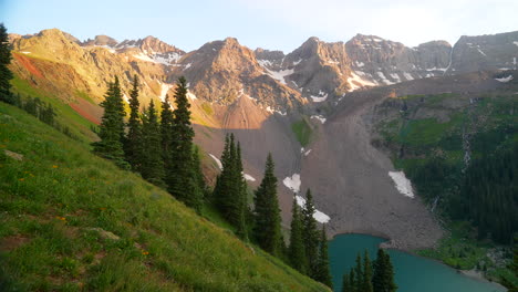 Gelbe-Wildblumen-Mount-Sniffels-Peaks-Wildnis-Oberer-Blauer-See-Colorado-Sommerschneeschmelze-Gipfel-Des-Felsigen-Berges-Atemberaubender-Sonnenuntergang-In-Goldener-Stunde-Silverton-Telluride-14er-Filmischer-Langsamer-Schwenk-Nach-Rechts