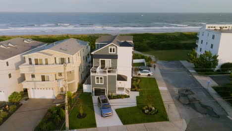 Aerial-view-tilting-over-a-seaside-home,-golden-hour-in-the-Brigantine-in-NJ,-USA