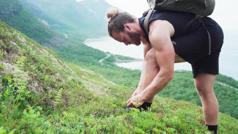 Hiker-Tying-His-Shoe-Lace-on-the-Mountain